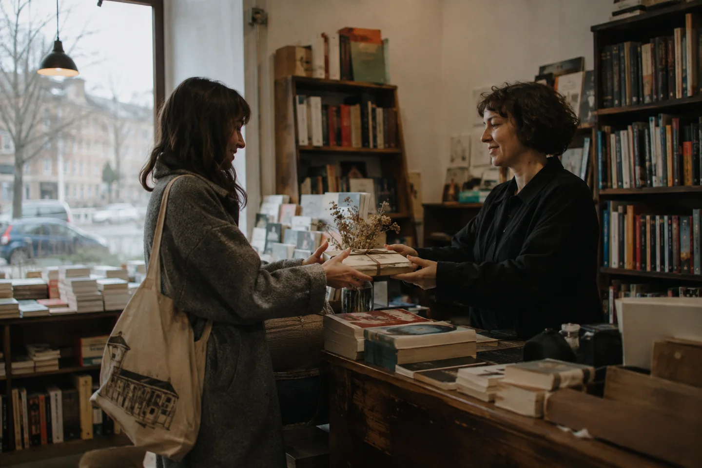 A bookseller hearing feedback directly from a customer at the counter